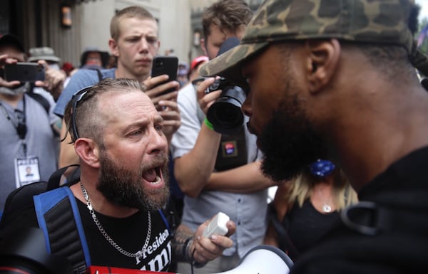 Scott Hilliard, left, argues with Black Lives Matter protester Eugene Smith ahead of President Donald Trump's campaign rally in Tulsa, Okla. Saturday, June 20, 2020. (Mike Simons/Tulsa World via AP)