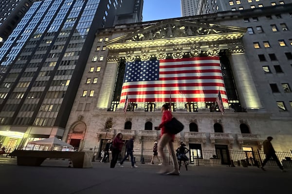 FILE - People pass the New York Stock Exchange on Nov. 5, 2024, in New York. (AP Photo/Peter Morgan, File)