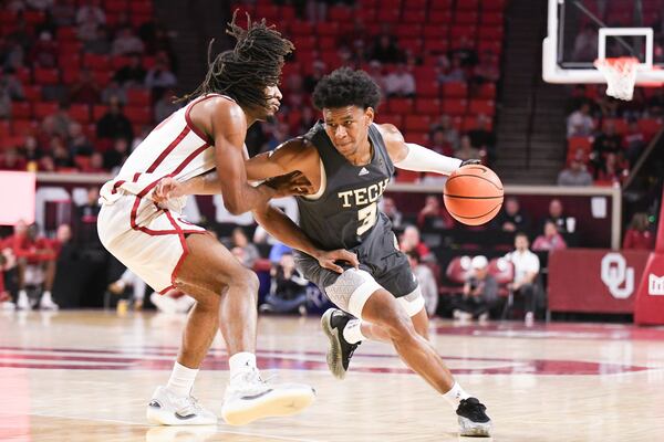 Georgia Tech guard Jaeden Mustaf, right, drives past Oklahoma forward Glenn Taylor Jr., left, during the second half of an NCAA college basketball game, Tuesday, Dec. 3, 2024, in Norman, Okla. (AP Photo/Kyle Phillips)