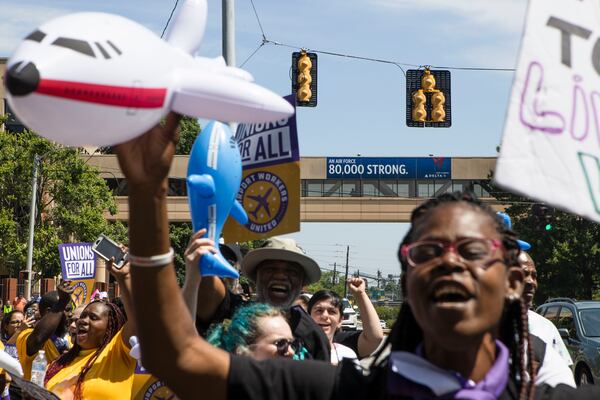 Protesters demonstrate in front of Delta Headquarters during the Airport Workers United march to Delta Headquarters on Saturday, June 3, 2023, in Atlanta. Over 200 protesters marched to demand higher wages. CHRISTINA MATACOTTA FOR THE ATLANTA JOURNAL-CONSTITUTION 