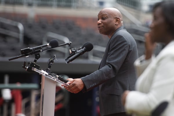 Howard Bryant, author of "The Last Hero: A Life of Henry Aaron," speaks at the United States Postal Service Hank Aaron Commemorative Forever Stamp First Day of Issue Dedication Ceremony at Truist Park in Atlanta on Wednesday, July 31, 2024.  (Ziyu Julian Zhu / AJC)