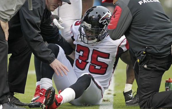 Team members assist Atlanta Falcons' Antone Smith (35) after Smith was injured in the second half of an NFL football game against the Carolina Panthers in Charlotte, N.C., Sunday, Nov. 16, 2014. (AP Photo/Bob Leverone)