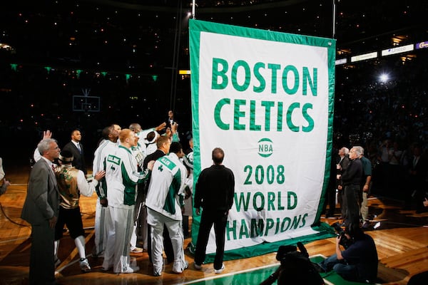 FILE - Boston Celtics players and team personnel gather to raise the Celtics' 17th NBA championship banner during ceremonies prior to an NBA basketball game against the Cleveland Cavaliers in Boston on Tuesday, Oct. 28, 2008. (AP Photo/Winslow Townson, File)