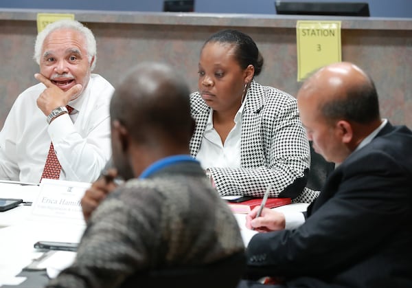 DeKalb County Elections Board members Samuel Tillman and (from left) Anthony Lewis, elections director Erica Hamilton, and Baoky Vu at a November 2018 meeting. Curtis Compton/ccompton@ajc.com