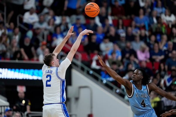 Duke forward Cooper Flagg (2) shoots against Mount St. Mary's forward Dola Adebayo (4) during the first half in the first round of the NCAA college basketball tournament, Friday, March 21, 2025, in Raleigh, N.C. (AP Photo/Stephanie Scarbrough)