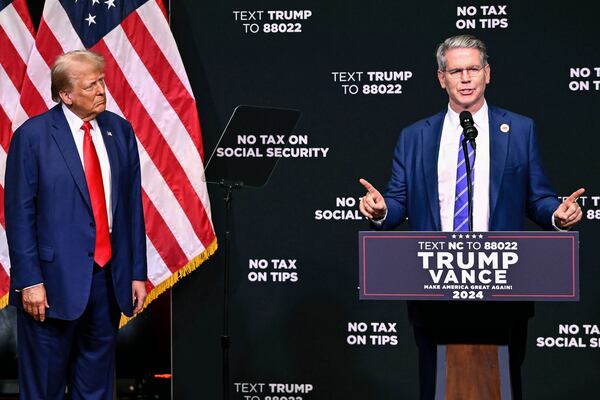 FILE - Republican presidential nominee former President Donald Trump, left, listens as investor Scott Bessent speaks on the economy in Asheville, N.C., Aug. 14, 2024. (AP Photo/Matt Kelley, File)