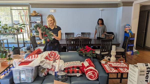 Volunteers Amy Williams and Carla Jackson prepare Christmas decorations for one of two campus houses in Kennesaw State University’s Ascend Community that serve once-homeless students. The Cobb Community Foundation connects volunteers to nonprofits and projects addressing various needs in the county. Courtesy of Leadership Cobb Alumni Association