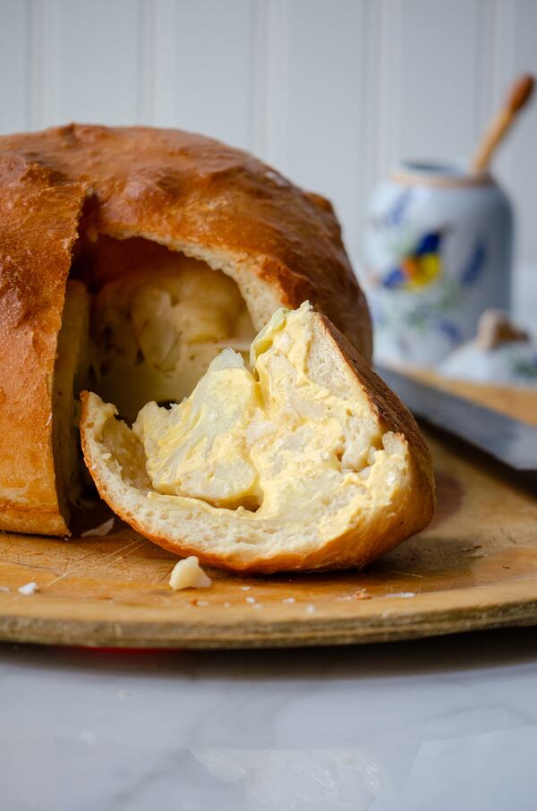 Cauliflower en Croute — whole cauliflower topped with Swiss cheese and baked in pizza dough — is a chef-inspired recipe achievable for the home cook. (Virginia Willis for The Atlanta Journal-Constitution)