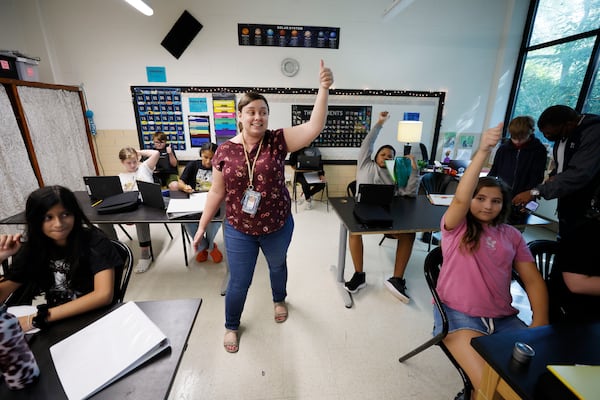 Science teacher Jennifer Mayer (center) engages with students at Tapestry Public Charter School on Thursday, Aug. 31, 2023, in Doraville. Tapestry adopts an inclusive approach, enrolling 50% neurodivergent (special needs) students and 50% without special needs. They aim to replicate this model in Atlanta to meet the growing demand. The school board has repeatedly postponed the voting process, but a vote is scheduled for Tuesday, Sept. 5, 2023. (Miguel Martinez / miguel.martinezjimenez@ajc.com)