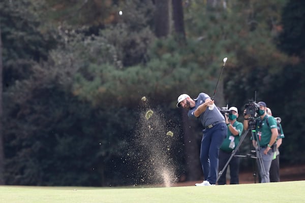 Dustin Johnson hits his second shot on the 18th green during the final round of the Masters Tournament Sunday, Nov. 15, 2020, at Augusta National. (Curtis Compton / Curtis.Compton@ajc.com)