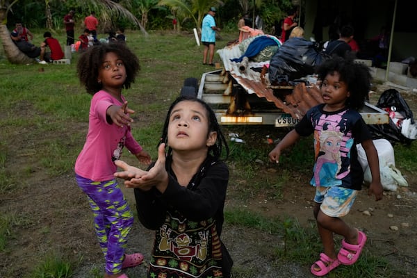 Children of Venezuelan migrants play ball in Puerto Cartí, on Panama's Caribbean coast, Saturday, Feb. 22, 2025, where their families are camping out before boarding boats to Colombia on their way back from southern Mexico after giving up hopes of reaching the U.S. amid President Trump's crackdown on migration. (AP Photo/Matias Delacroix)