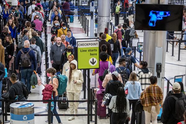 Travelers stand in line to go through the security checkpoint at Hartsfield-Jackson Atlanta International Airport during a busy Friday morning, October 28, 2022. (Steve Schaefer/steve.schaefer@ajc.com)