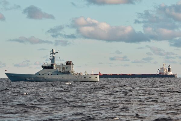 The Chinese ship, the bulk carrier Yi Peng 3, in background, is anchored and being monitored by a Danish naval patrol vessels in the sea of Kattegat, near the city of Granaa in Jutland, Denmark, Wednesday, Nov. 20, 2024. (Mikkel Berg Pedersen/Ritzau Scanpix via AP)