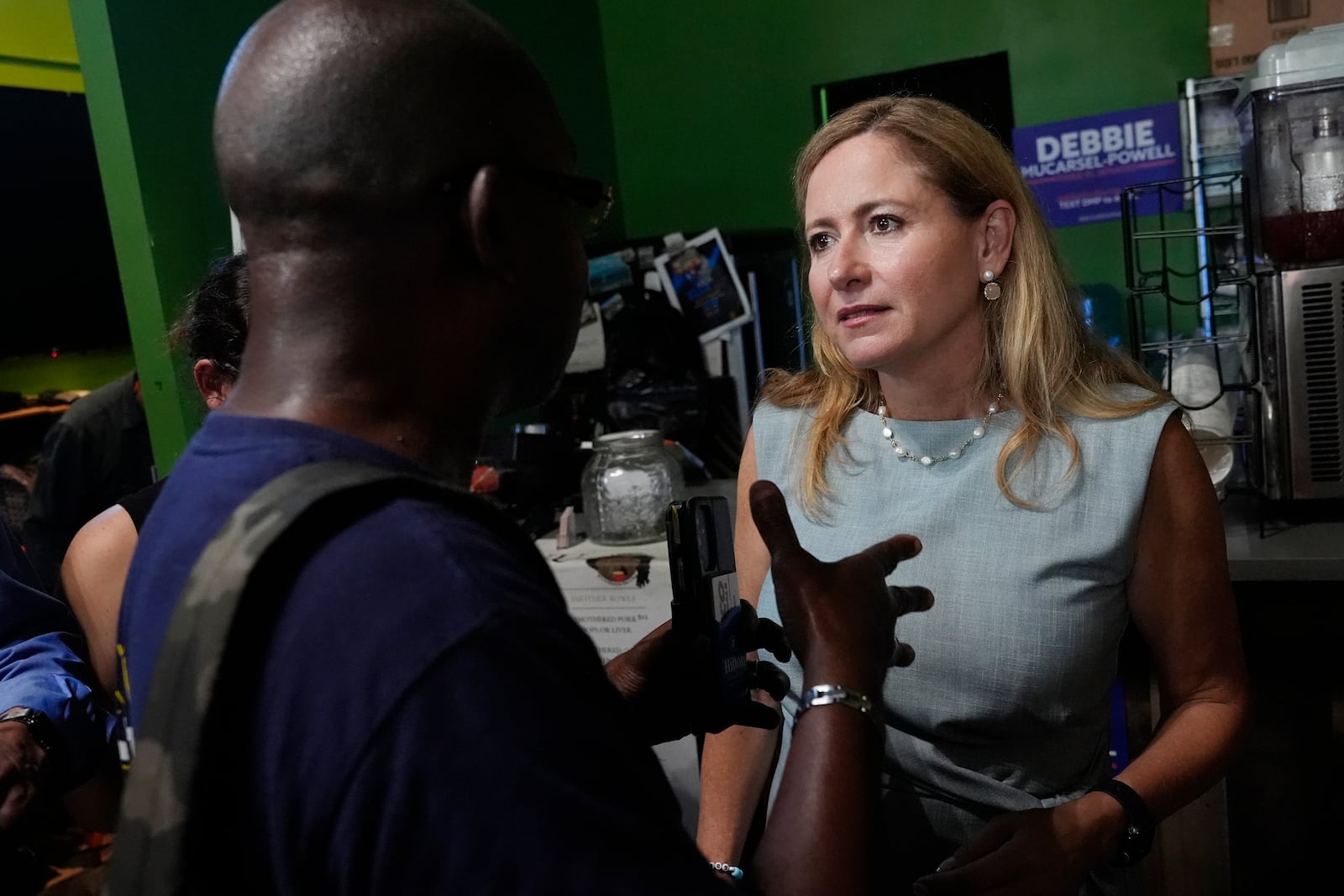 FILE - Democratic candidate for the U.S. Senate, Debbie Mucarsel-Powell listens to a supporter at a campaign event, Tuesday, Oct. 1, 2024, in Miami. (AP Photo/Marta Lavandier, File)