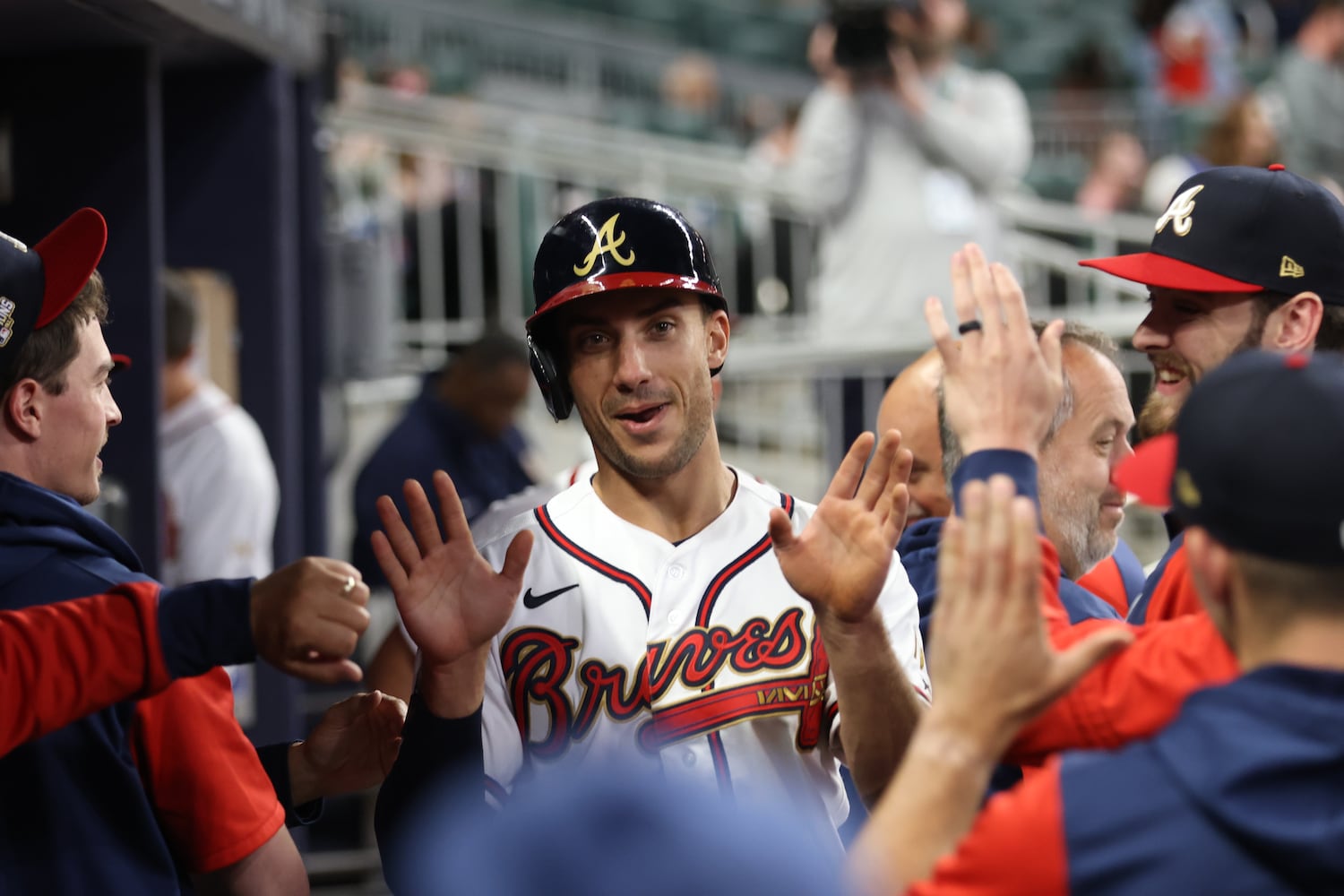 Braves first baseman Matt Olson celebrates with teammates in the dugout Monday night at Truist Park. (Miguel Martinez/miguel.martinezjimenez@ajc.com)