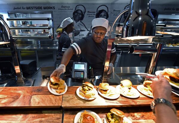 Antonia Thomas serves foods at The West Nest concession stand during a tour of Mercedes-Benz Stadium on Tuesday, August 15, 2017. The West Nest is part of Westside Works, a program started by the Arthur Blank Family Foundation as part of an attempt to turn around Vine City and English Avenue, two of the city’s poorest neighborhoods. HYOSUB SHIN / HSHIN@AJC.COM