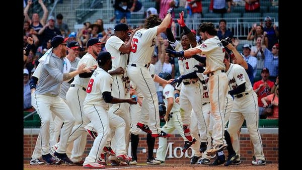 Charlie Culberson is mobbed by his teammates after another walk-off homer Sunday. (Photo by Daniel Shirey/Getty Images)