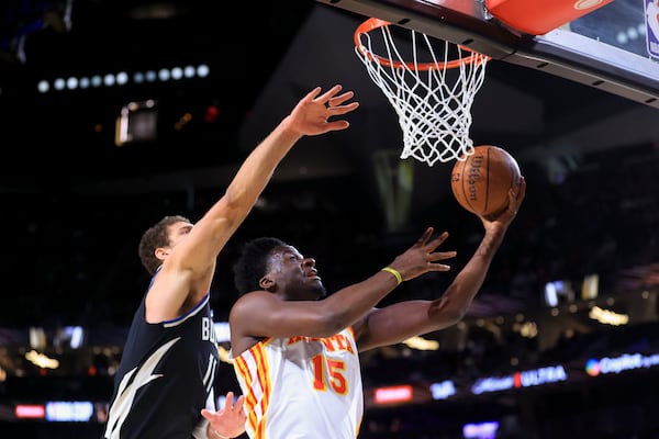 Atlanta Hawks center Clint Capela (15) shoots against Milwaukee Bucks center Brook Lopez (11) during the first half of a semifinal game in the NBA Cup basketball tournament Saturday, Dec. 14, 2024, in Las Vegas. (AP Photo/Ian Maule)