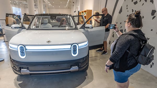 Sabrina Eijan takes a photograph of the new Rivian R2 prototype that will eventually be made in Georgia at the Ponce City Market in Atlanta on April 27, 2024.  (Steve Schaefer / AJC)