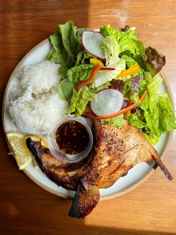 Circle Sushi’s hamachi kama (yellowtail collar) comes with rice and a choice of salad or soup. It's shown here with salad. (Wendell Brock for The Atlanta Journal-Constitution)