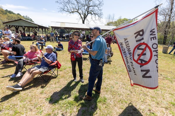 Alan Jenkins (Right) talks to friends at the Rivian Opposition Barbecue fundraiser in Rutledge Saturday, March 25, 2023.  (Steve Schaefer/steve.schaefer@ajc.com)