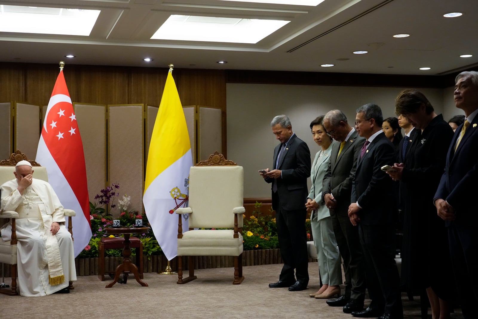 Pope Francis, left, waits for the Prime Minister of Singapore, Lawrence Wong at the Parliament House in Singapore, Thursday, Sept. 12, 2024. Pope Francis flew to Singapore on Wednesday for the final leg of his trip through Asia, arriving in one of the world's richest countries from one of its poorest after a record-setting final Mass in East Timor. (AP Photo/Gregorio Borgia, pool)