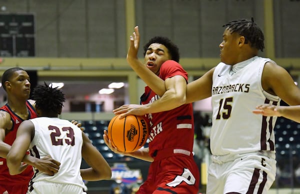 Sandy Creek's Myles Rice (2) attempts to protect the ball from Cross Creek's Corey Trotter (right) during the Class 3A boys championship game Friday, March 12, 2021, at the Macon Centreplex in Macon. Cross Creek won, 57-49. (Hyosub Shin / Hyosub.Shin@ajc.com)