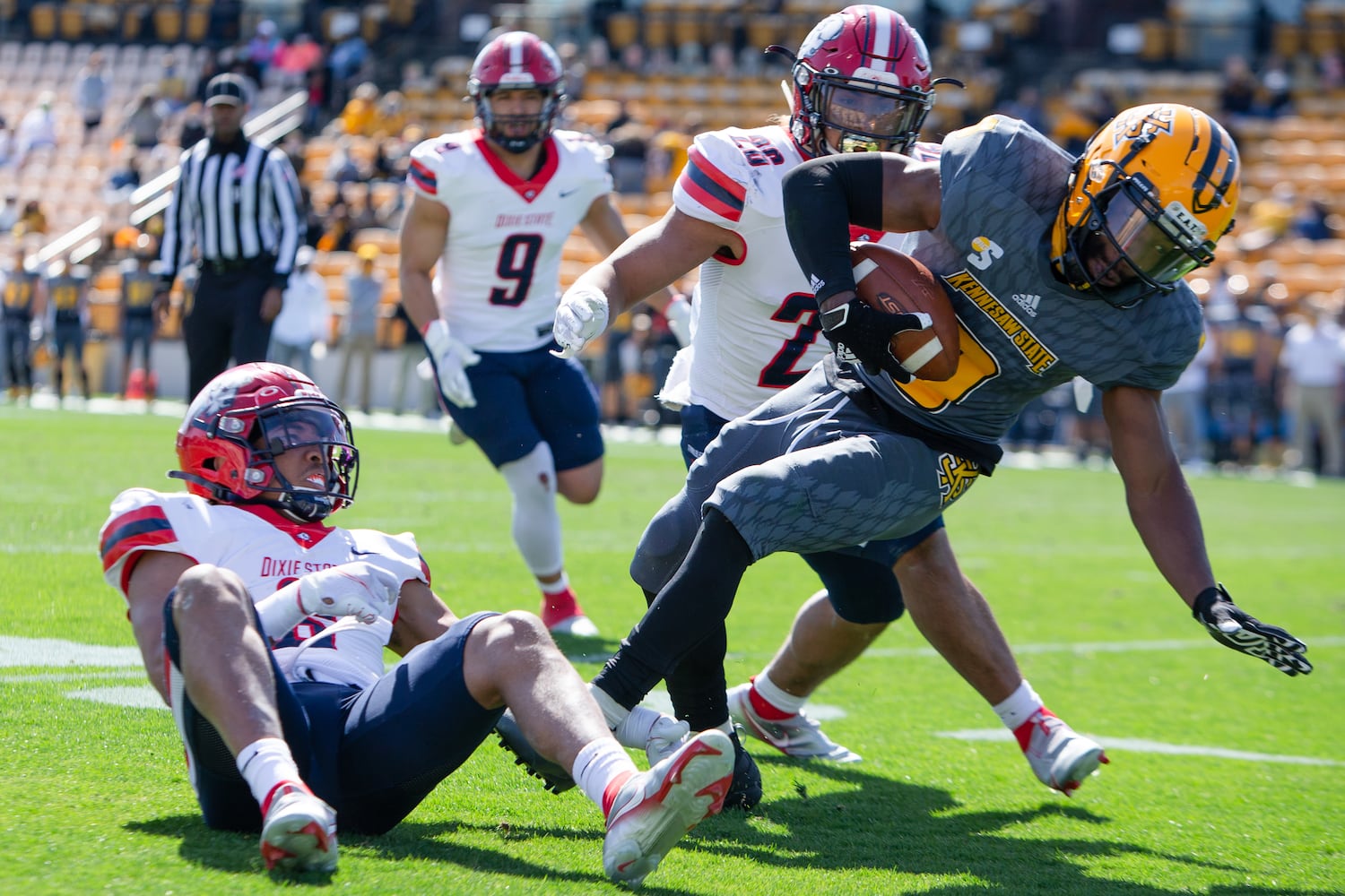 Xavier Shepherd (right), freshman quarterback for Kennesaw State, gets tackled by Brian Davison (left) of Dixie State. CHRISTINA MATACOTTA FOR THE ATLANTA JOURNAL-CONSTITUTION.