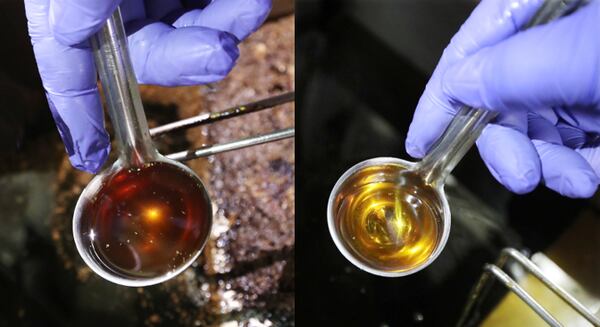 Filta franchise owner John Lopez checks fry oil before and after it is filtered at a concession stand in the Georgia World Congress Center on Thursday, Jan. 17, 2019, in Atlanta.