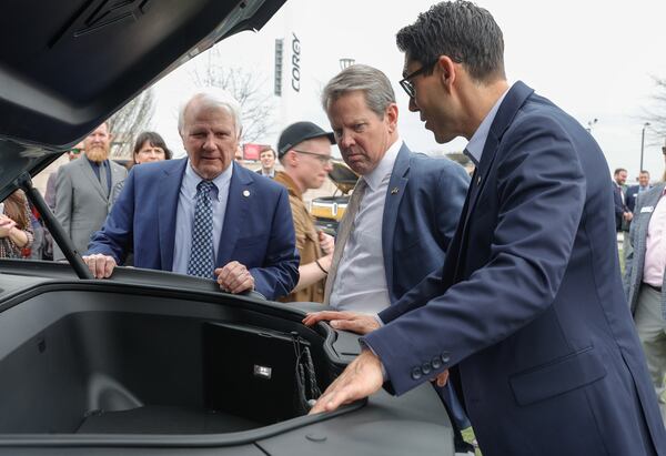 (Left to right) Georgia Speaker of the House Jon Burns, Gov. Brian Kemp and Rivian CEO RJ Scaringe look inside of the trunk of a Rivian electric vehicle following a news conference celebrating Rivian Day at the Georgia State Capitol on Wednesday, March 1,  2023. (Natrice Miller/ Natrice.miller@ajc.com)