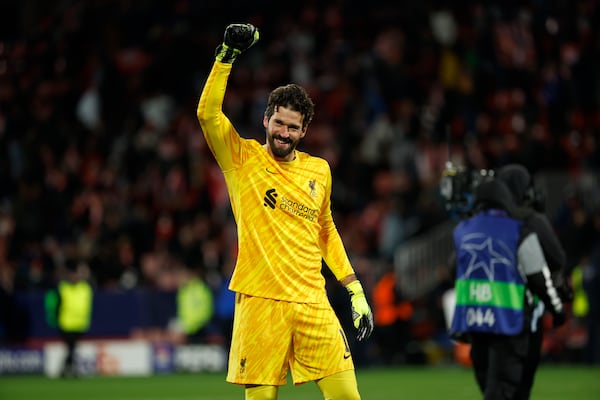 Liverpool's goalkeeper Alisson celebrates his victory in the Champions League soccer match against Girona at Estadi Montilivi in ​​Girona, Spain, on Tuesday, December 10, 2024. (AP Photo/Joan Monfort)