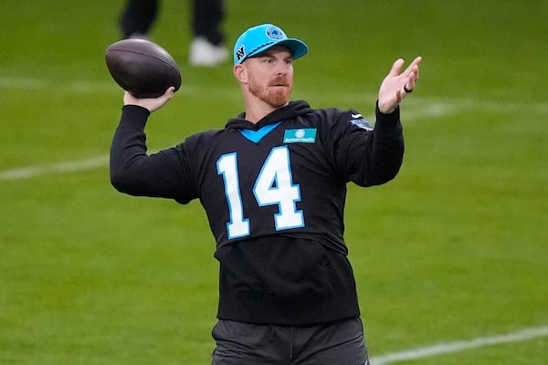 Carolina Panthers quarterback Andy Dalton (14) throws a ball during practice session in Munich, Germany, Friday, Nov. 8, 2024. The Carolina Panthers are set to play the New York Giants in an NFL game at the Allianz Arena in Munich on Sunday Nov. 10. (AP Photo/Matthias Schrader)