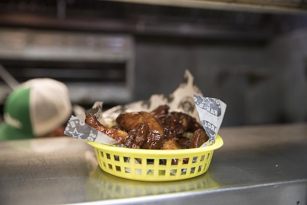 Smoked chicken wings are served at Fox Bros. Bar-B-Q near Atlanta’s Little Five Points community. ALYSSA POINTER / ALYSSA.POINTER@AJC.COM