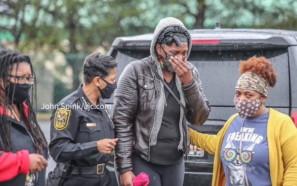 Elizabeth Grisby (center) is supported by DeKalb County police Chief Mirtha Ramos (left) during the search for Grisby's 1-year-old daughter.