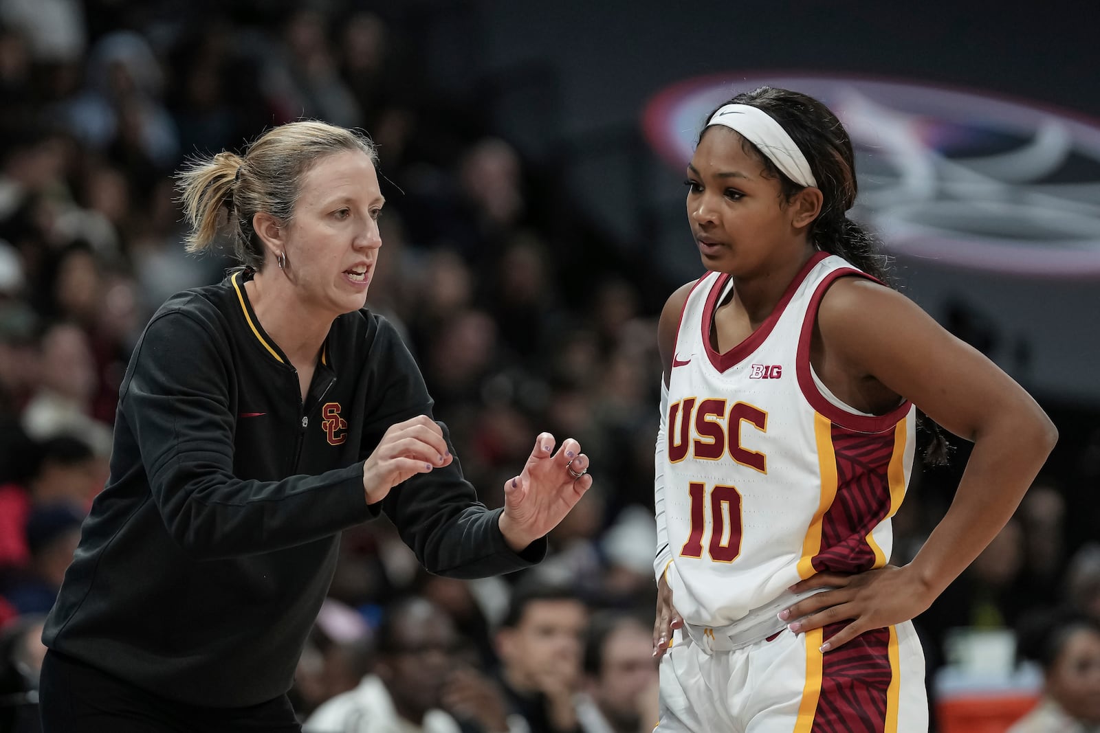 USC Trojans's coach Lindsay Gottlieb, right, talks with USC Trojans's guard Malia Samuels, left, during the basketball match between the University of Southern California (USC) and Ole Miss, Monday, Nov. 4, 2024 in Paris, France. (AP Photo/Aurelien Morissard)