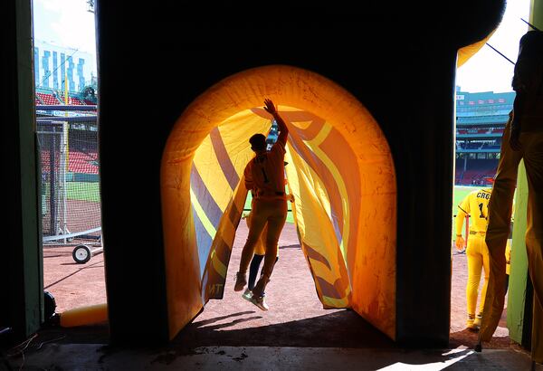 Savannah Bananas' Bill LeRoy jumps inside the tunnel leading onto the outfield of Fenway Park after greeting fans under the grandstands.  The Savannah Bananas took their World Tour to a sold-out Fenway Park on Saturday, June 8, 2024, as they played the Party Animals before over 37,000 fans in Boston.  (John Tlumacki/The Boston Globe)