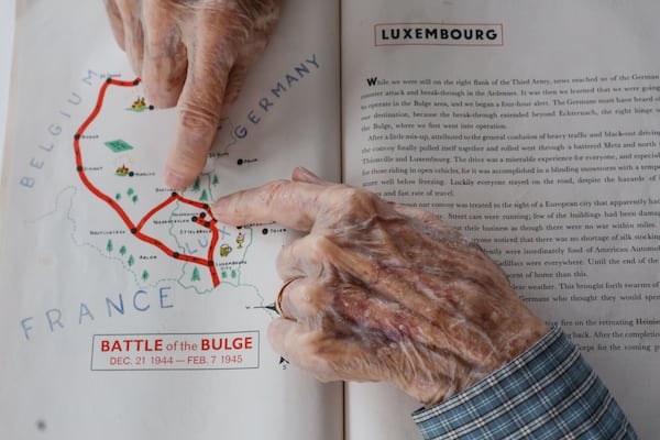 Alan Kinder points to routes he took in Luxembourg during World War II. Kinder, along with other WWII veterans, will visit Normandy for the commemoration of the 80th anniversary of D-Day in June. ( Natrice Miller/ AJC)