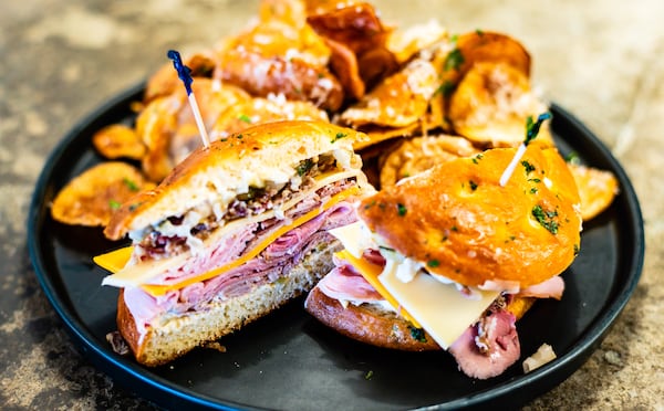 The muffuletta at The Butcher The Baker on Marietta Square is essentially a top-flight charcuterie board piled onto a sandwich. CONTRIBUTED BY HENRI HOLLIS