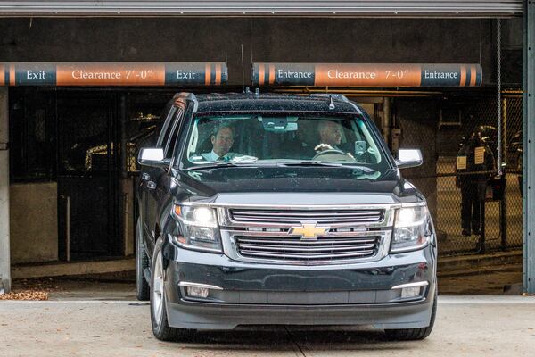 Gov. Brian Kemp, in a vehicle, leaves the Fulton County Courthouse in Atlanta on Tuesday after testifying before a special grand jury investigating whether former President Donald Trump and his allies criminally meddled in Georgia’s 2020 elections. (Arvin Temkar / arvin.temkar@ajc.com)