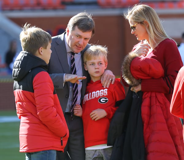 Georgia head coach Kirby Smart appears to coach up his sons Weston (left) and Andrew (right) as his wife Mary Beth looks on in Jordan-Hare Stadium as his team arrives to play Auburn in a NCAA college football game on Saturday, November 16, 2019, in Auburn.   Curtis Compton/ccompton@ajc.com