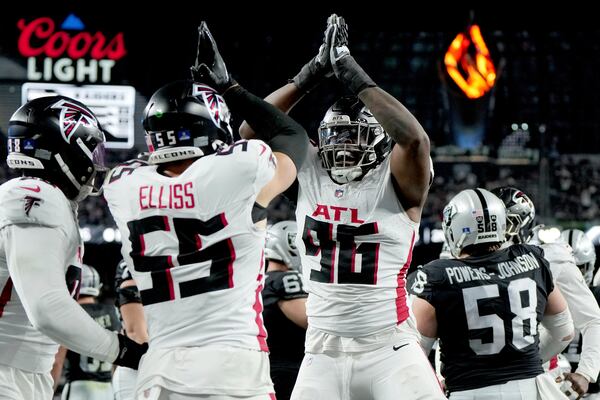 Atlanta Falcons defensive end Zach Harrison (96) and linebacker Kaden Elliss (55) celebrate a safety against the Las Vegas Raiders during the first half of an NFL football game on Monday, Dec. 16, 2024, in Las Vegas. (AP Photo/Rick Scuteri)