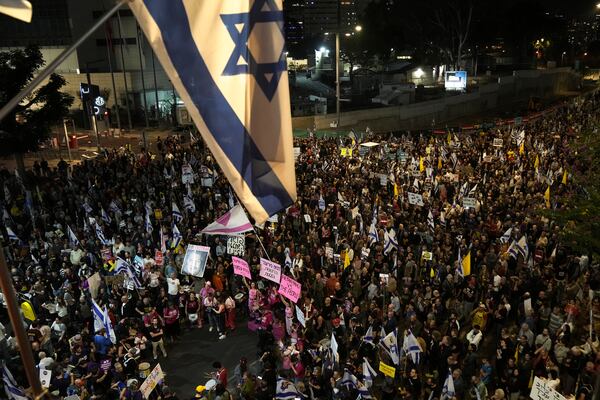 People gather to protest against Prime Minister Benjamin Netanyahu's government and call for the release of hostages held in the Gaza Strip by the Hamas militant group, in Tel Aviv, Israel, Saturday, Nov. 23, 2024. (AP Photo/Maya Alleruzzo)