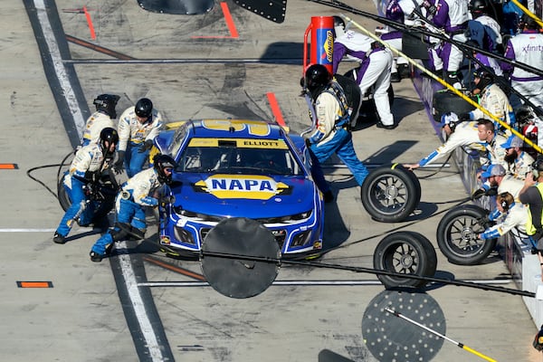 Crew members perform a pit stop on driver Chase Elliott's car during a NASCAR Cup Series auto race at Martinsville Speedway in Martinsville, Va., Sunday, Nov. 3, 2024. (AP Photo/Chuck Burton)