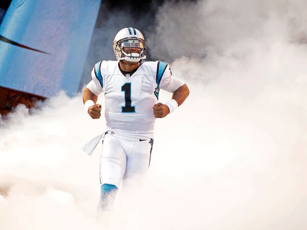 Cam Newton bursts onto the field for the Carolina Panthers' preseason game against the Miami Dolphins on Aug. 22 in Charlotte. The Panthers won 31-30. AP Photo/Bob Leverone