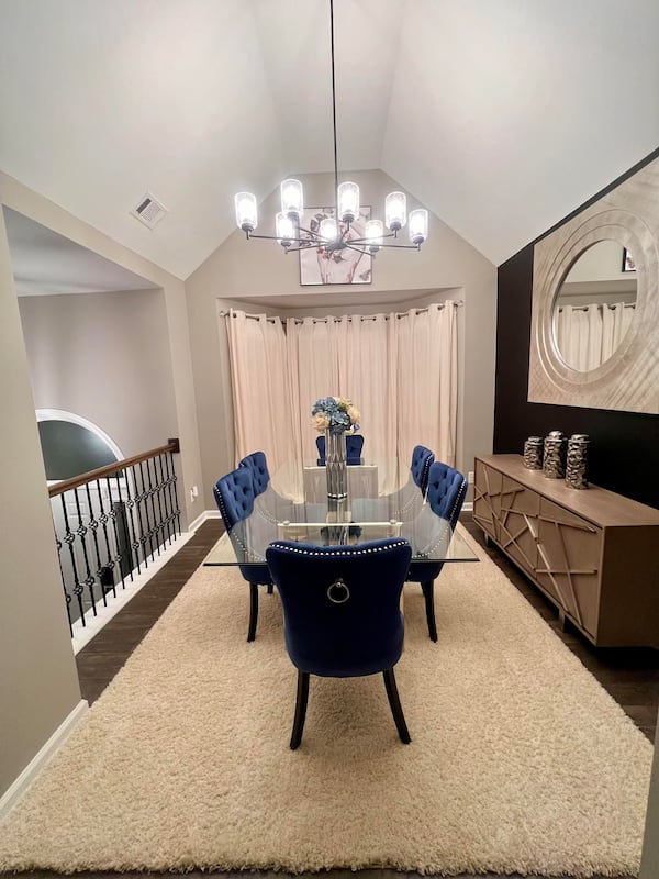 A dining area with a pop of blue chairs from Onyx and Annah Interiors.