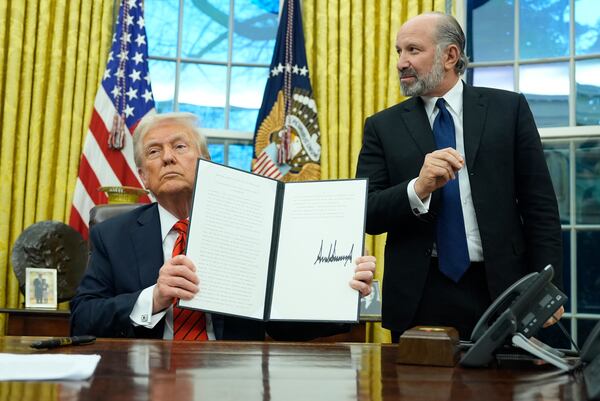 President Donald Trump hold a proclamation regarding steel imports as he speaks in the Oval Office at the White House, Monday, Feb. 10, 2025, in Washington, as Commerce Secretary nominee Howard Lutnick watches. (Alex Brandon/AP)