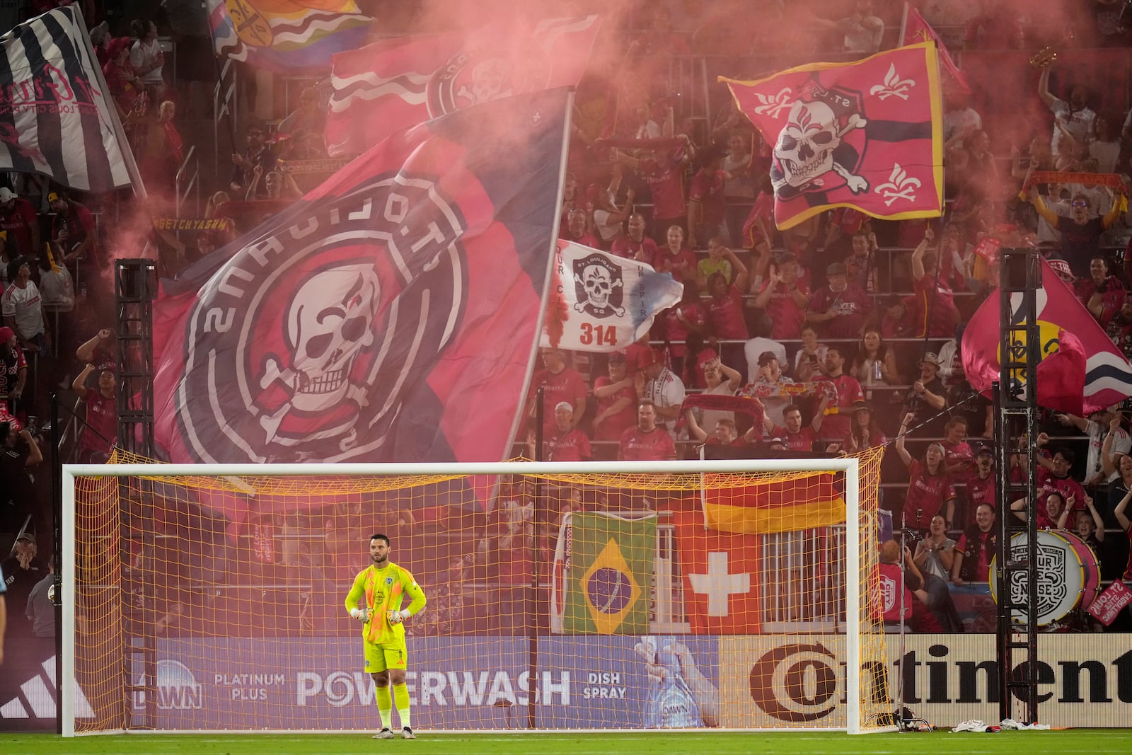 St. Louis City fans celebrate a goal by Cedric Teuchert as Sporting Kansas City goalkeeper John Pulskamp pauses during the first half of an MLS soccer match Saturday, Sept. 28, 2024, in St. Louis. (AP Photo/Jeff Roberson)