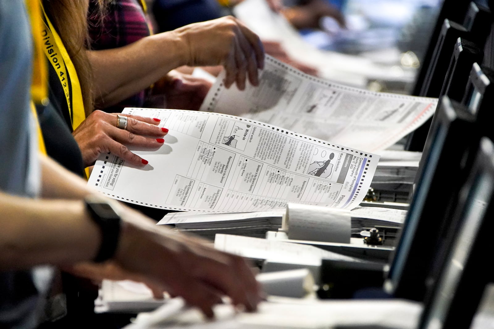 FILE - Election workers perform a recount of ballots from the recent Pennsylvania primary election at the Allegheny County Election Division warehouse in Pittsburgh on June 1, 2022. (AP Photo/Gene J. Puskar, File)