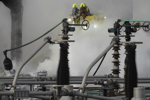 Firefighters extinguish the fire at the North Hyde electrical substation, which caught fire Thursday night and lead to a closure of Heathrow Airport in London, Friday, March 21, 2025.(AP Photo/Kirsty Wigglesworth)