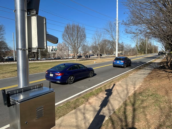 Traffic passes an automated speed camera outside Beacon Hill Middle School in Decatur, Ga., on Tuesday, Feb. 25, 2025. (AP Photo/Jeff Amy)